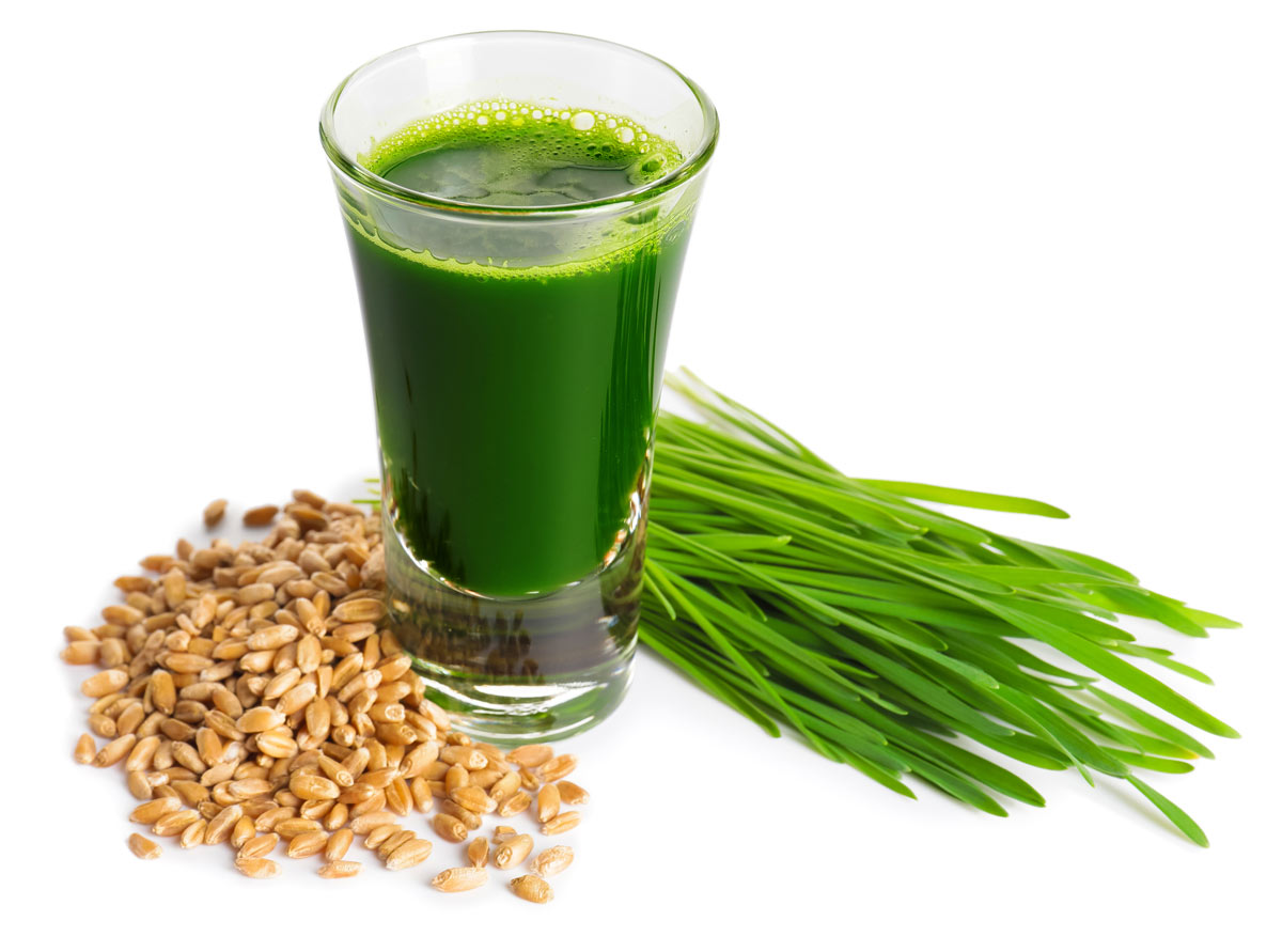 dark fresh wheatgrass drink with seeds and grass