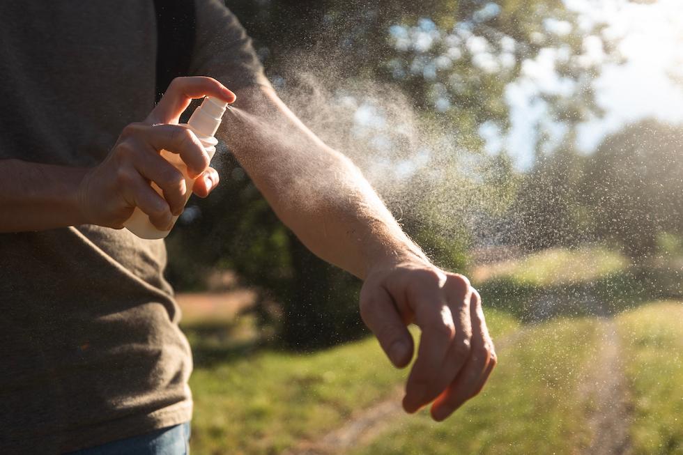man spraying arm